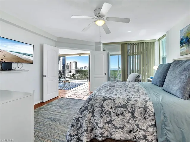 a living room with a bed furniture and a large window