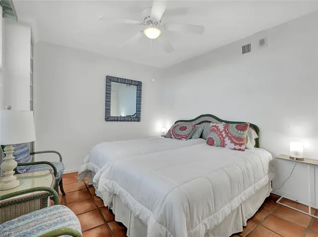 a bedroom with a bed and lamp