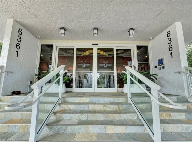 a front view of a house with stairs