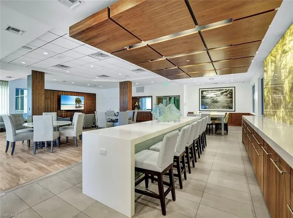 a large white kitchen with lots of furniture and counter space