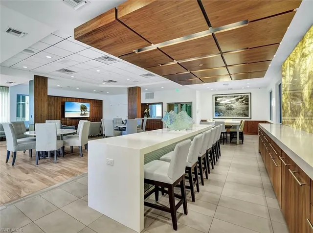 a large white kitchen with lots of furniture and counter space