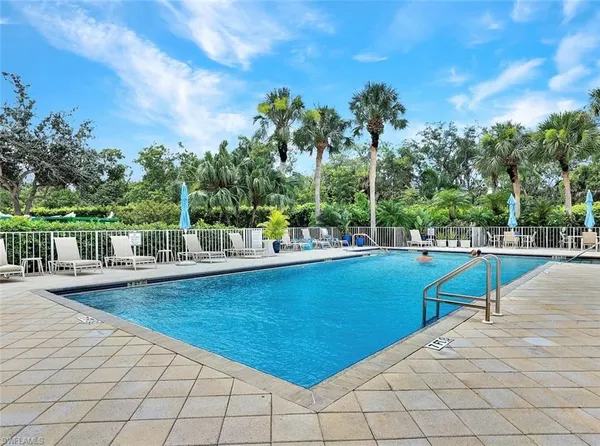 a view of a swimming pool with an outdoor seating
