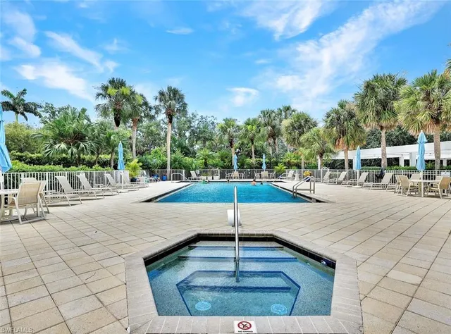 a view of a swimming pool with an outdoor seating