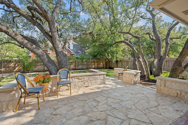 a view of a house with backyard and sitting area