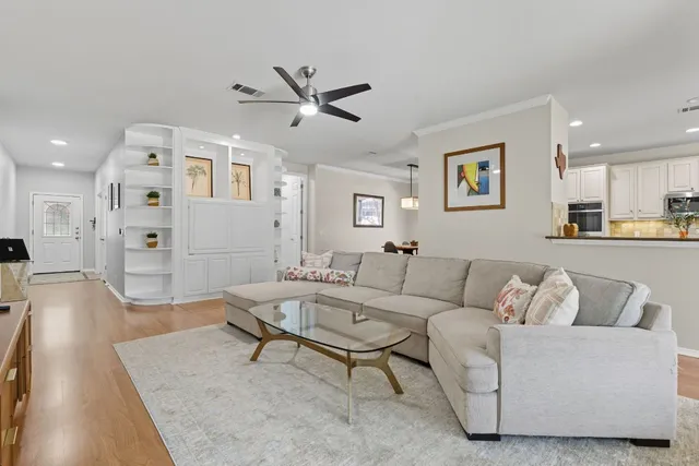 a living room with furniture and kitchen view