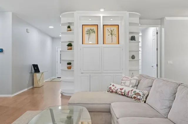 a living room with furniture and a glass door shower