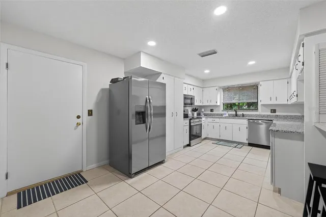 a kitchen with a sink cabinets and window