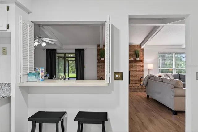 a kitchen with granite countertop white cabinets and stainless steel appliances
