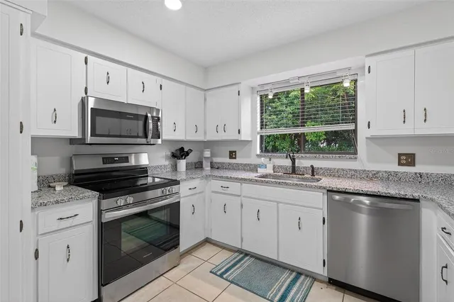 a bedroom with bed and a chandelier
