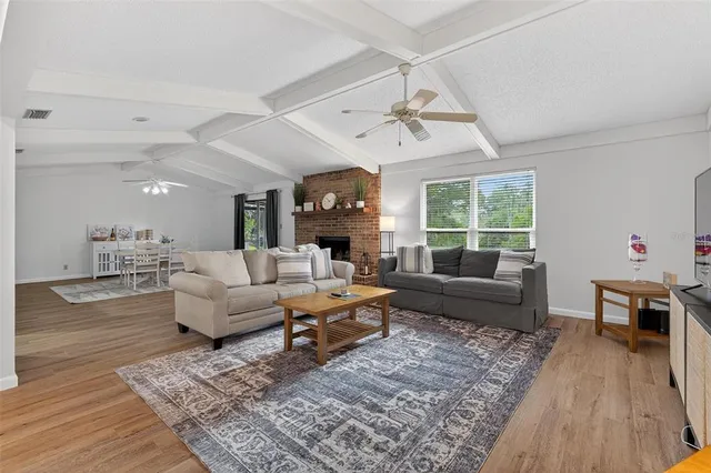 a living room with furniture or kitchen view and a wooden floor