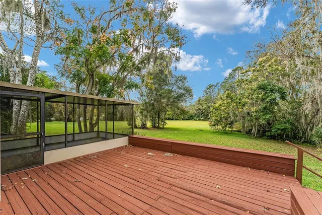 a view of house with backyard and outdoor seating