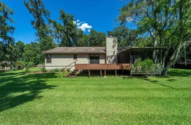 a view of a house with a backyard