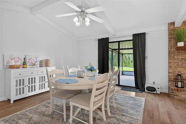 a view of a dining room with furniture window and wooden floor