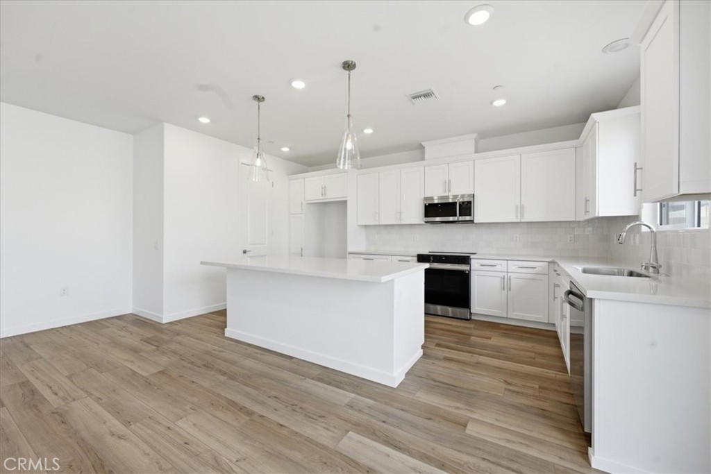 42957 56th Street West Lancaster, CA 93536 - Photo 12 of 40 a kitchen with a white wooden cabinets and white stainless steel appliances