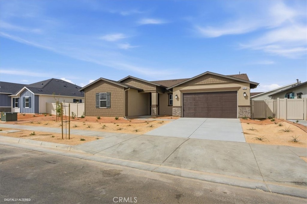 42957 56th Street West Lancaster, CA 93536 - Photo 2 of 40 a front view of a house with a yard and garage