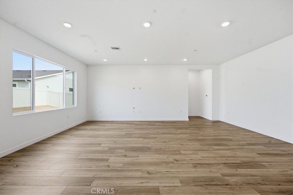 42957 56th Street West Lancaster, CA 93536 - Photo 21 of 40 a view of an empty room with wooden floor and a window