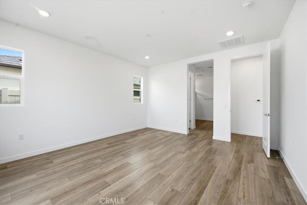 42957 56th Street West Lancaster, CA 93536 - Photo 23 of 40 a view of an empty room with wooden floor