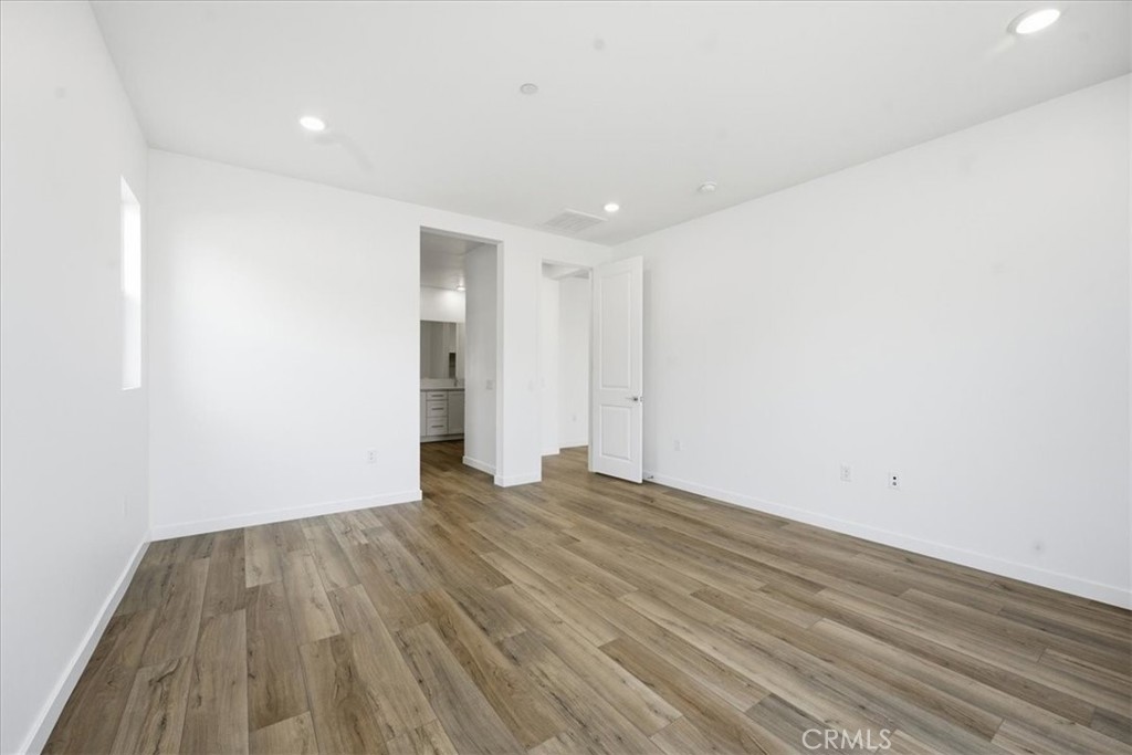 42957 56th Street West Lancaster, CA 93536 - Photo 24 of 40 a view of an empty room with wooden floor and closet
