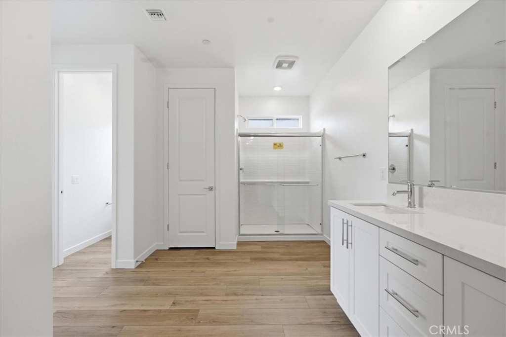 42957 56th Street West Lancaster, CA 93536 - Photo 28 of 40 a bathroom with a granite countertop sink mirror and shower