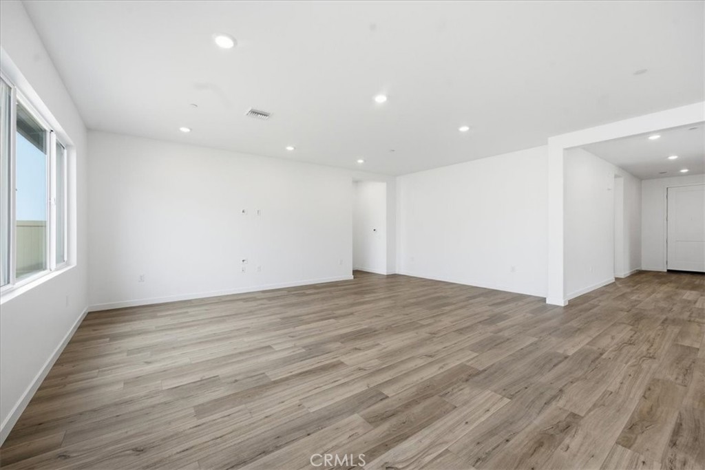 42957 56th Street West Lancaster, CA 93536 - Photo 8 of 40 a view of empty room with wooden floor and fan