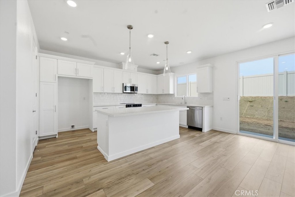 42957 56th Street West Lancaster, CA 93536 - Photo 10 of 40 a view of a kitchen with wooden floor