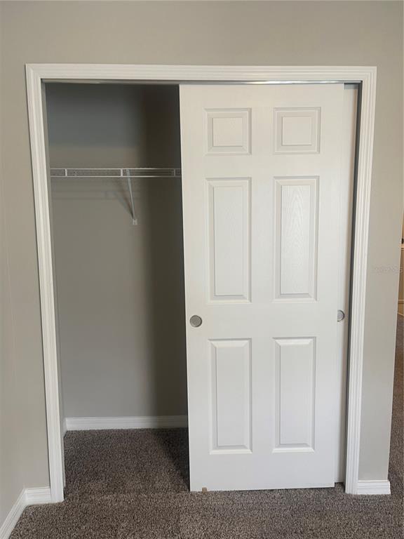 452 Legacy Loop Davenport, FL 33896 - Photo 15 of 29 an empty room with wooden floor