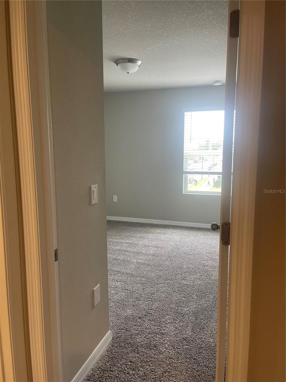 452 Legacy Loop Davenport, FL 33896 - Photo 16 of 29 a view of an empty room and window