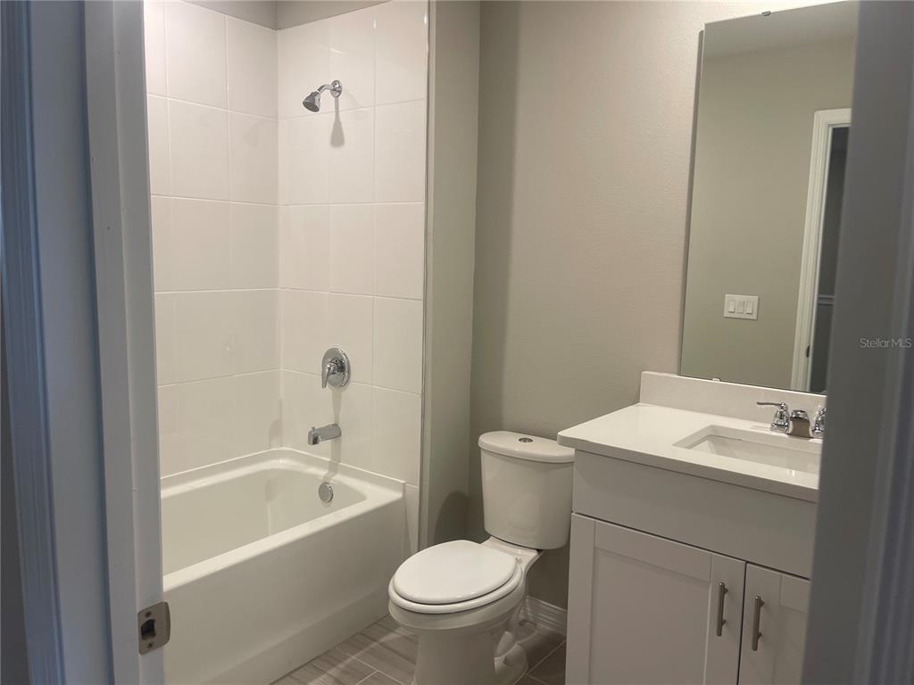 452 Legacy Loop Davenport, FL 33896 - Photo 18 of 29 a bathroom with a sink a toilet and shower