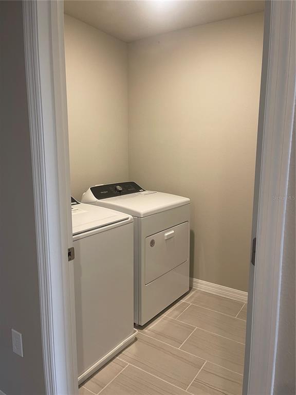 452 Legacy Loop Davenport, FL 33896 - Photo 20 of 29 a utility room with dryer and washer