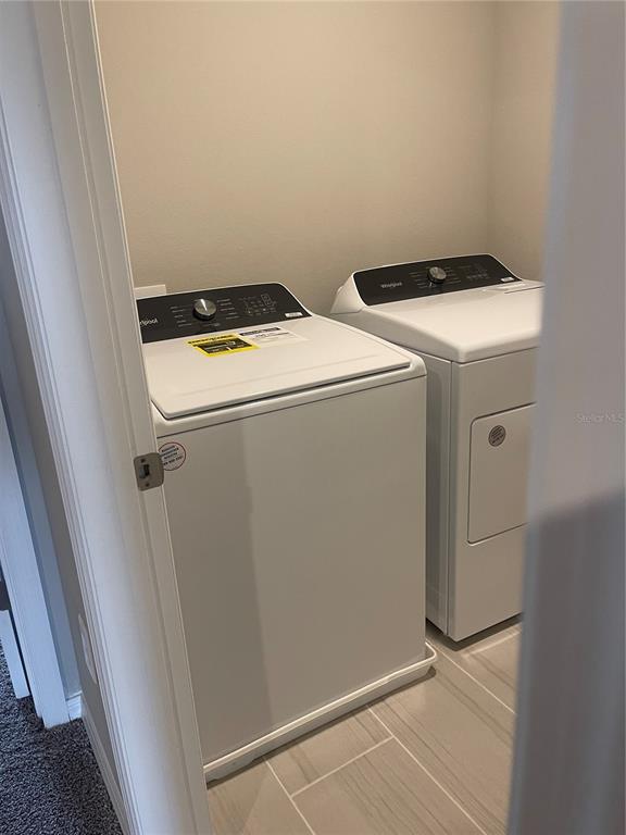 452 Legacy Loop Davenport, FL 33896 - Photo 21 of 29 a utility room with dryer and washer
