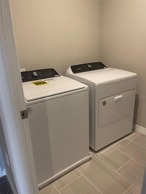 452 Legacy Loop Davenport, FL 33896 - Photo 22 of 29 a utility room with dryer and washer