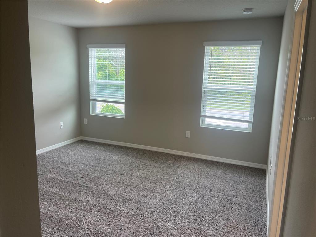 452 Legacy Loop Davenport, FL 33896 - Photo 25 of 29 an empty room with a window