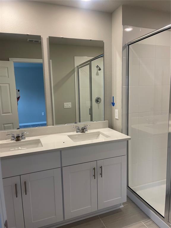 452 Legacy Loop Davenport, FL 33896 - Photo 27 of 29 a bathroom with a sink and a mirror