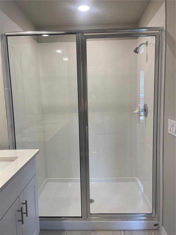 452 Legacy Loop Davenport, FL 33896 - Photo 28 of 29 a bathroom with a shower and a sink