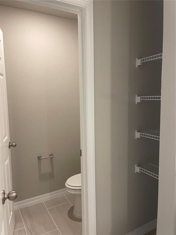 452 Legacy Loop Davenport, FL 33896 - Photo 29 of 29 a bathroom with a toilet and a shower