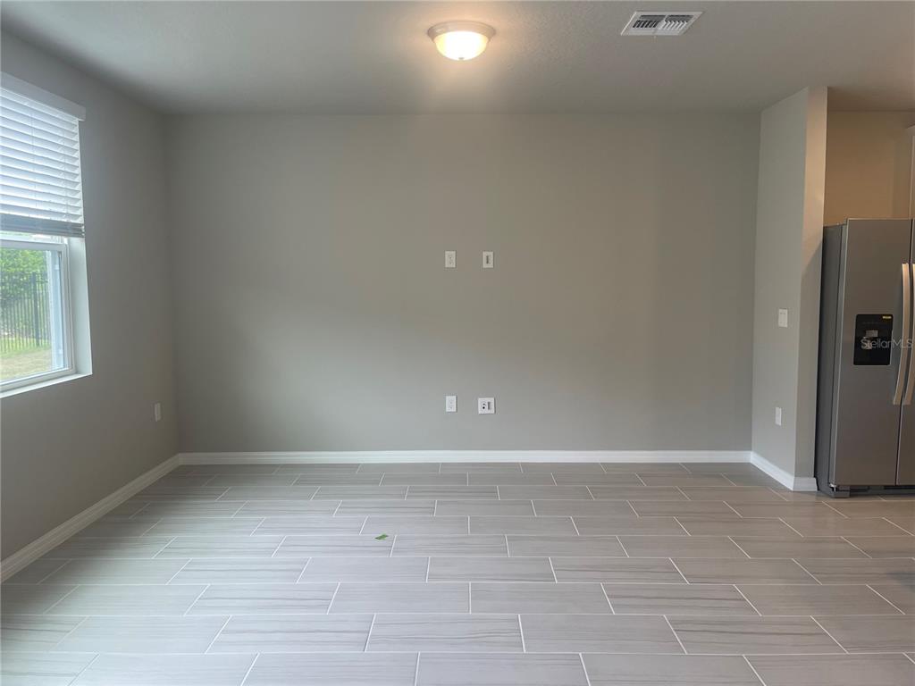 452 Legacy Loop Davenport, FL 33896 - Photo 8 of 29 a view of an empty room with a window
