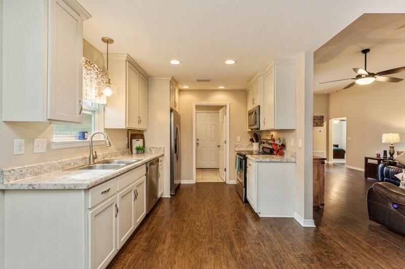3152 Vaccari Court Crestview, FL 32539 - Photo 11 of 36 a kitchen with sink cabinets and wooden floor