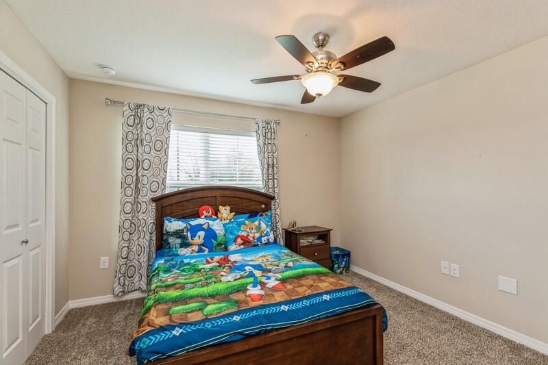 3152 Vaccari Court Crestview, FL 32539 - Photo 23 of 36 a bedroom with a bed and a chandelier