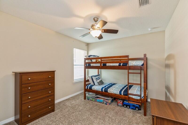 3152 Vaccari Court Crestview, FL 32539 - Photo 26 of 36 a bedroom with a bunk bed and a chandelier