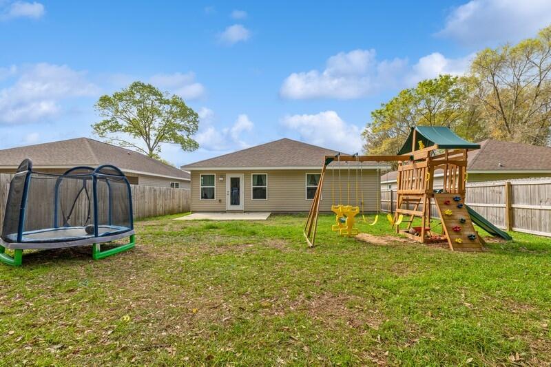 3152 Vaccari Court Crestview, FL 32539 - Photo 32 of 36 a view of a house with a backyard