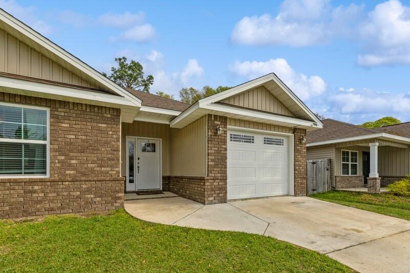 3152 Vaccari Court Crestview, FL 32539 - Photo 36 of 36 a front view of a house with a yard and garage