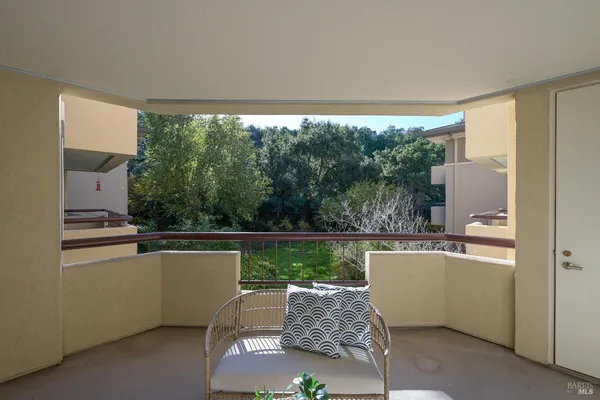 a living room with a floor to ceiling window and a couch