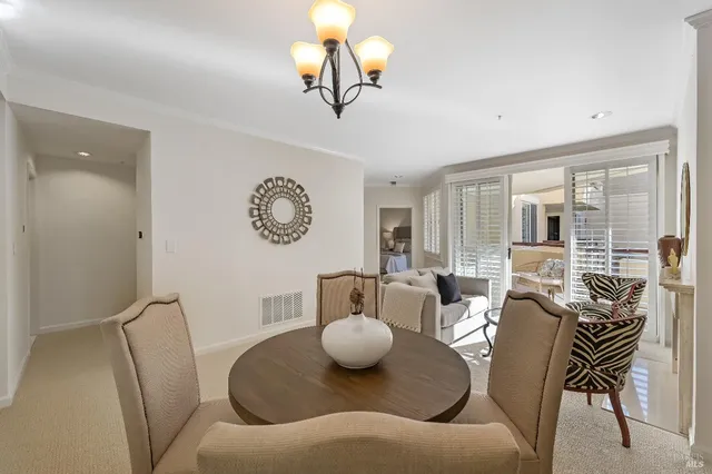 a living room with furniture a rug and a large window