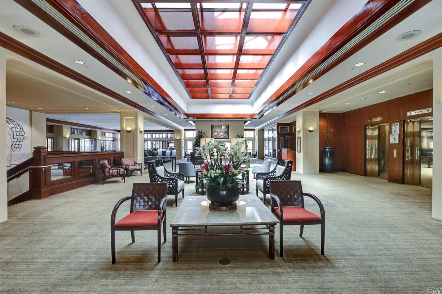 400 Deer Valley Road, Unit 3K San Rafael, CA 94903 - Photo 24 of 25 Clubhouse lounge and meeting area. Restaurant is to the right. Bar is in the back left with a piano.