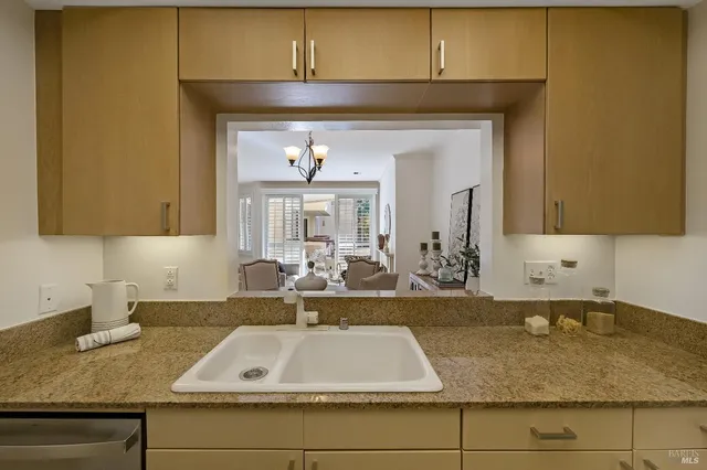 a view of a kitchen with a sink microwave and cabinets