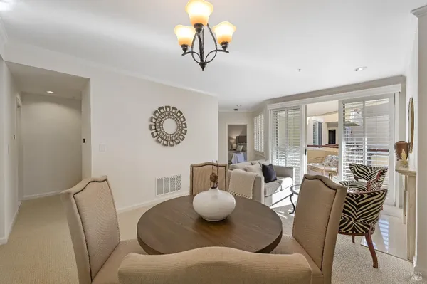 a living room with furniture a rug and a large window