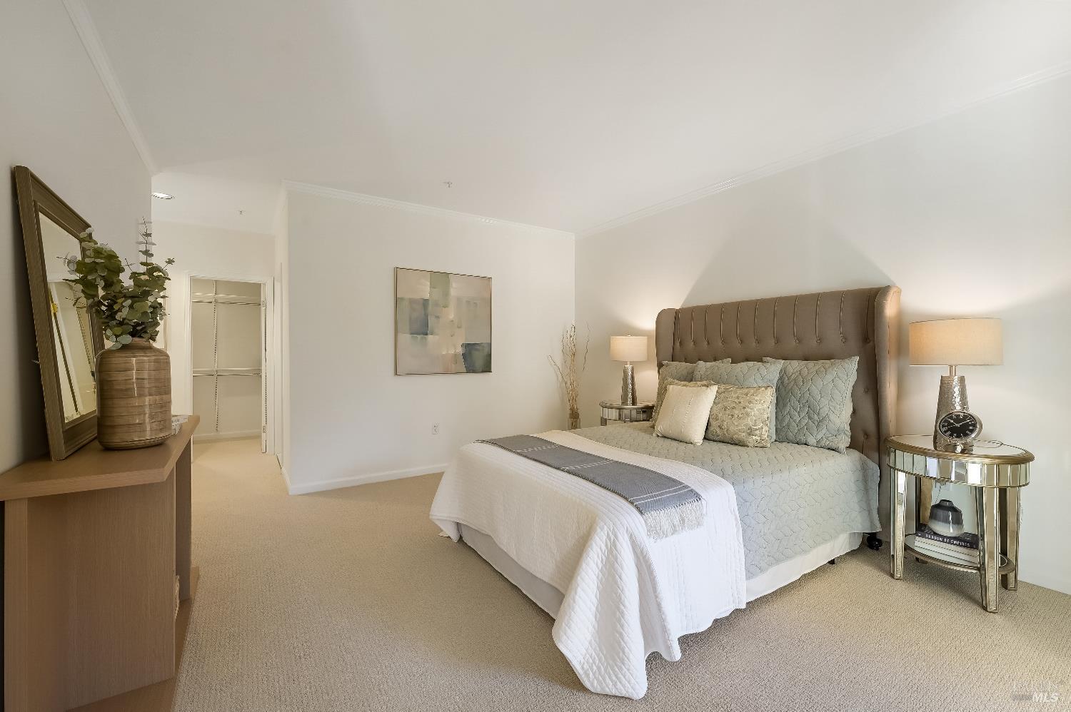 400 Deer Valley Road, Unit 3K San Rafael, CA 94903 - Photo 6 of 24 a bedroom with a bed a mirror and a flat tv screen on a dresser