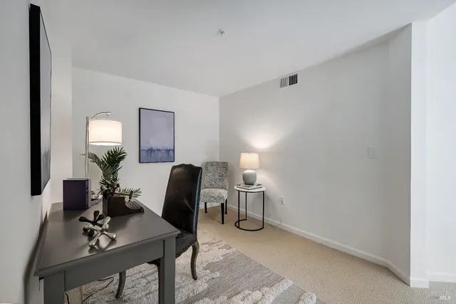 a living room with furniture and a mirror