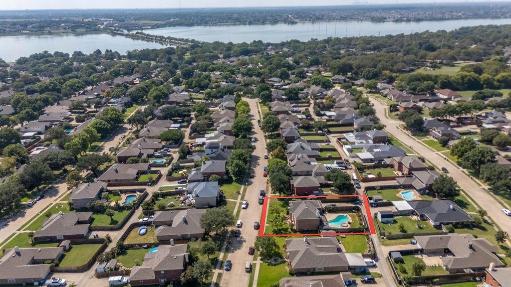 4113 Bluffpoint Road Rowlett, TX 75088 - Photo 3 of 39 Aerial perspective of suburban area with property parcel outlined and a nearby body of water