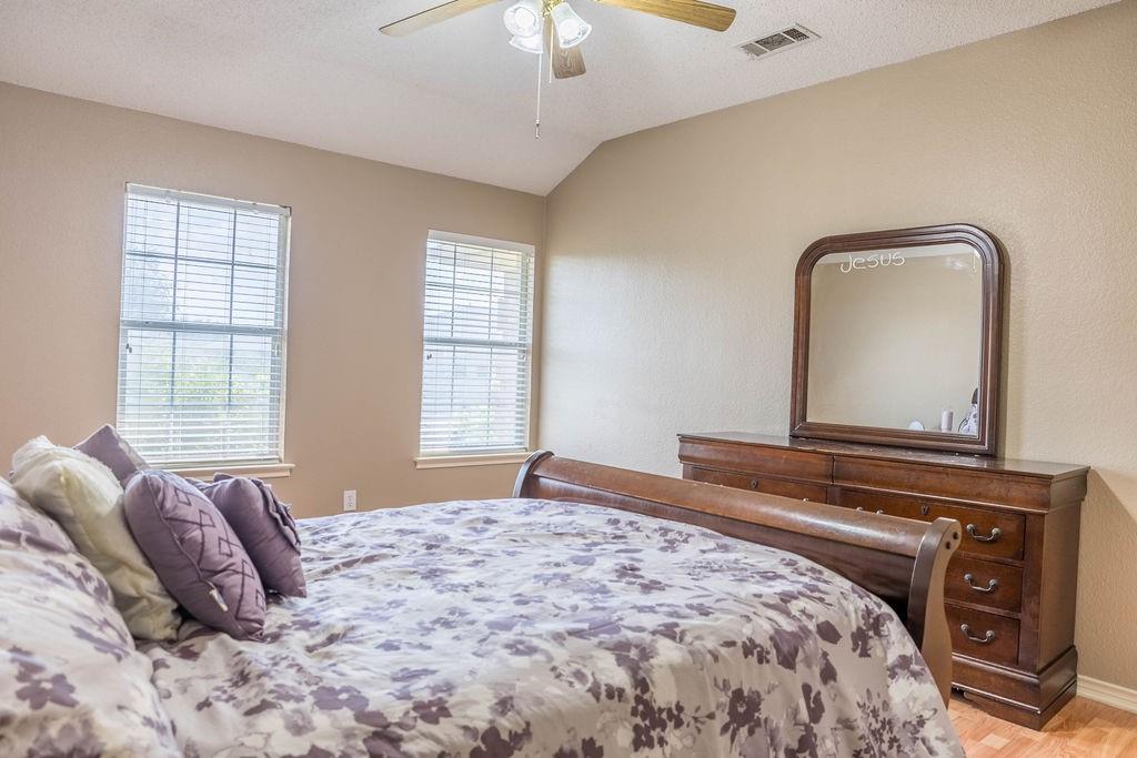 4113 Bluffpoint Road Rowlett, TX 75088 - Photo 32 of 39 Bedroom featuring lofted ceiling, light wood-style floors, and ceiling fan